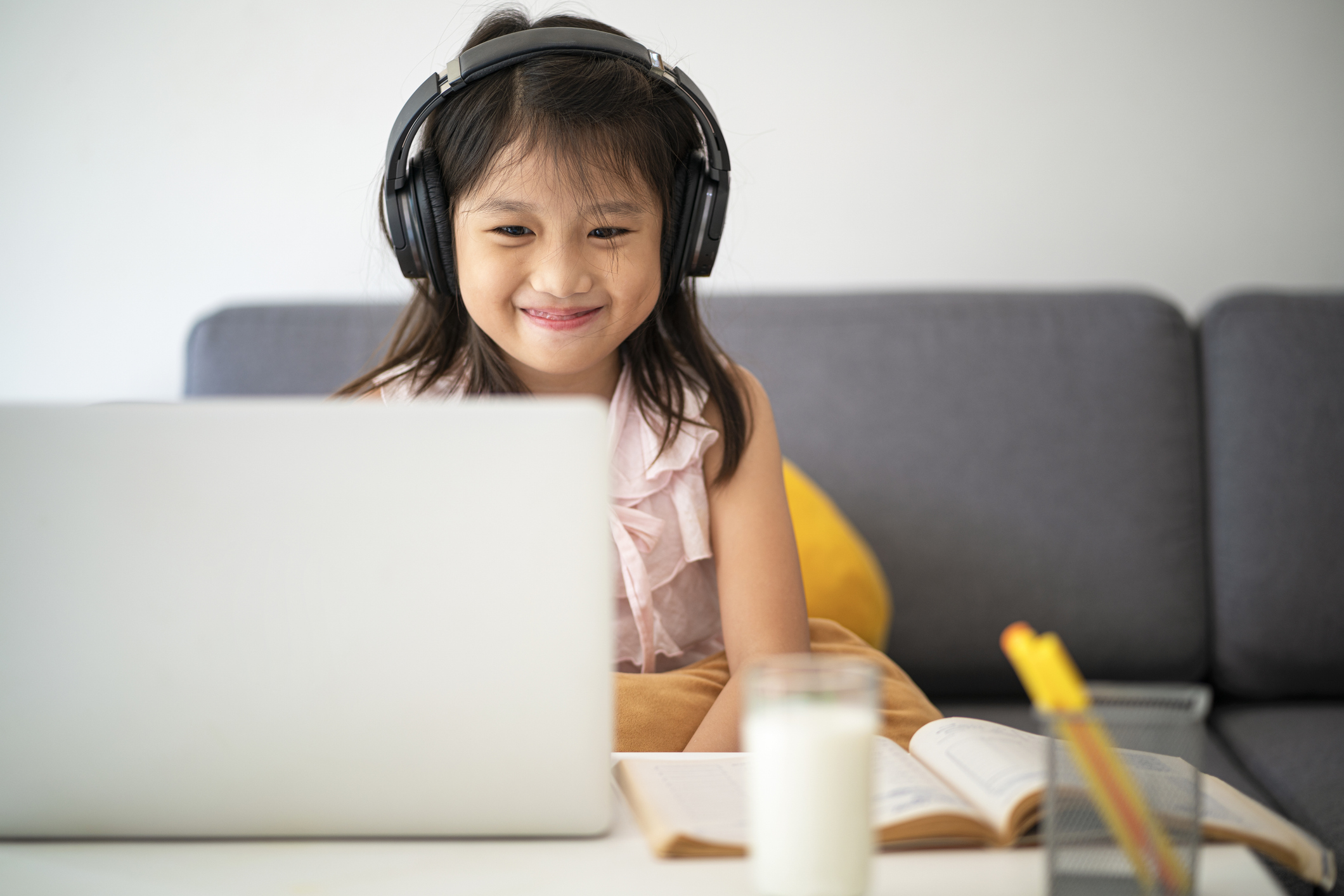 Asian girl using laptop for online study during homeschooling at home