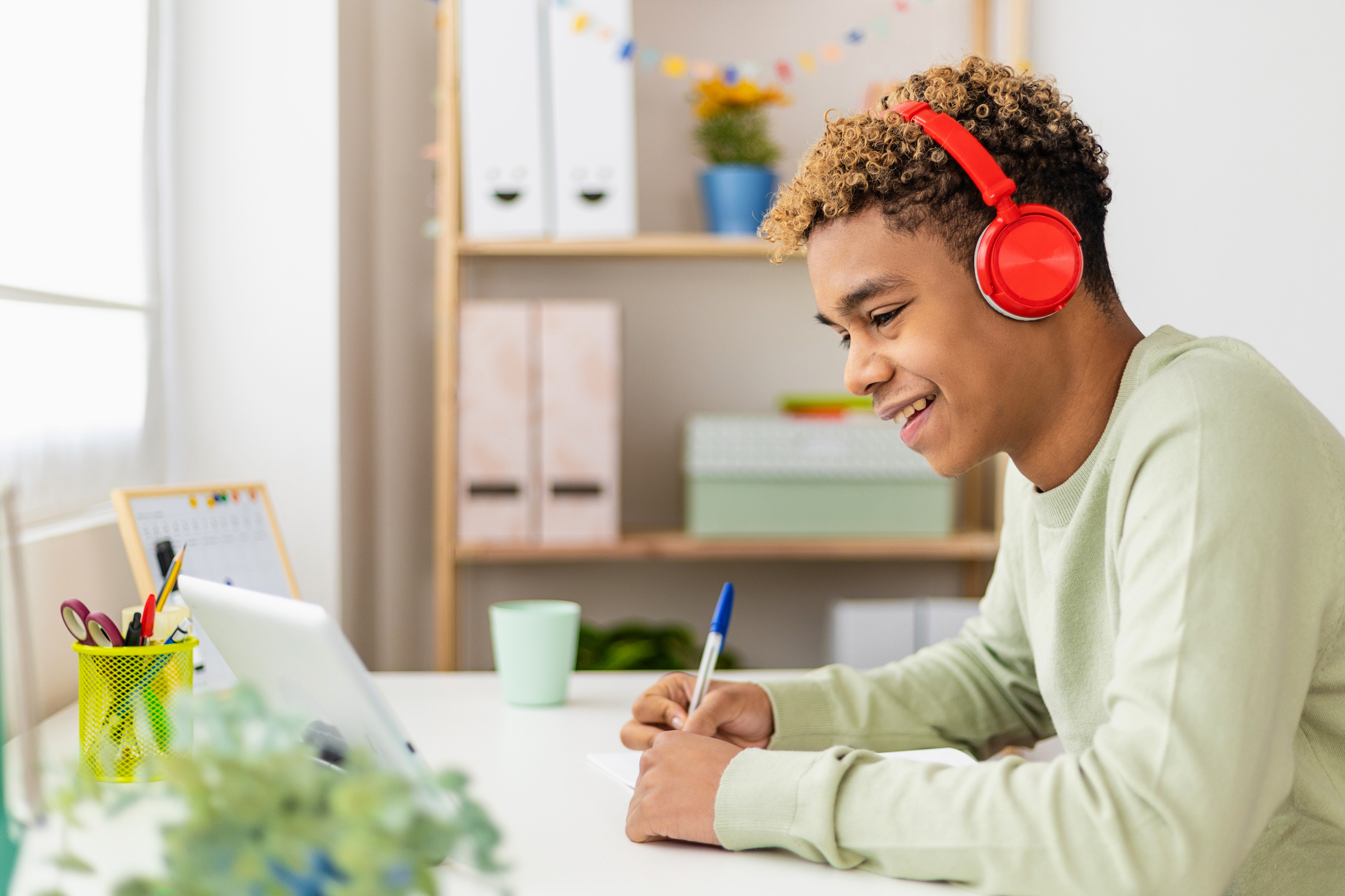 Smiling young hispanic latin man using digital table to study online at home Smiling young hispanic latin man using digital table to study online at home