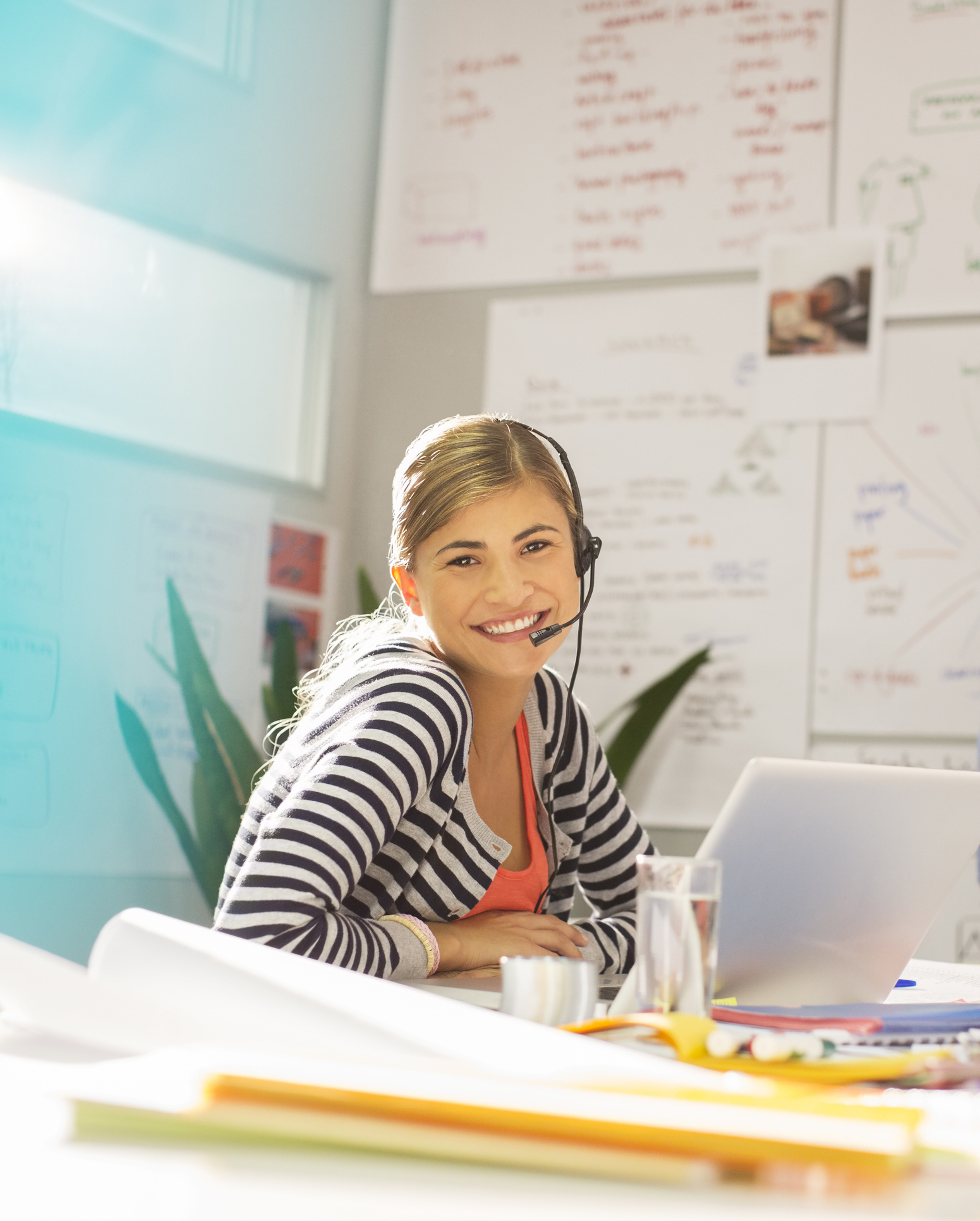 Businesswoman wearing headset at desk in office Headphones, study and girl with notebook in library