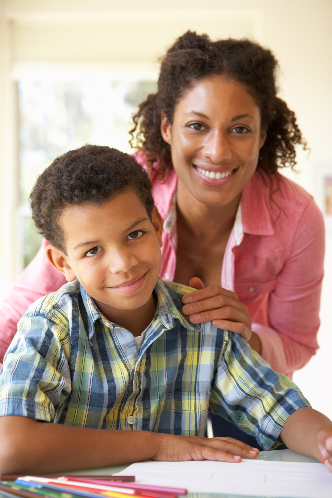 Mother Helping Son With Homework At Home full time student