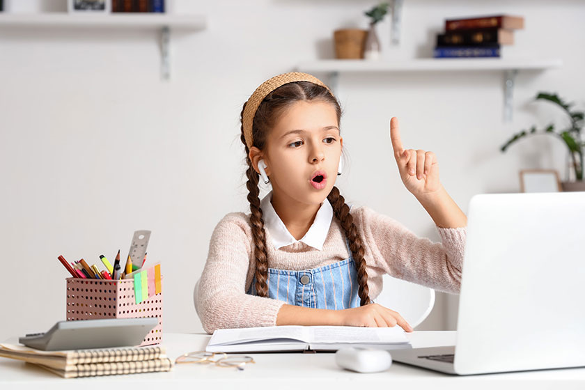 Little girl in earphones having idea while studying