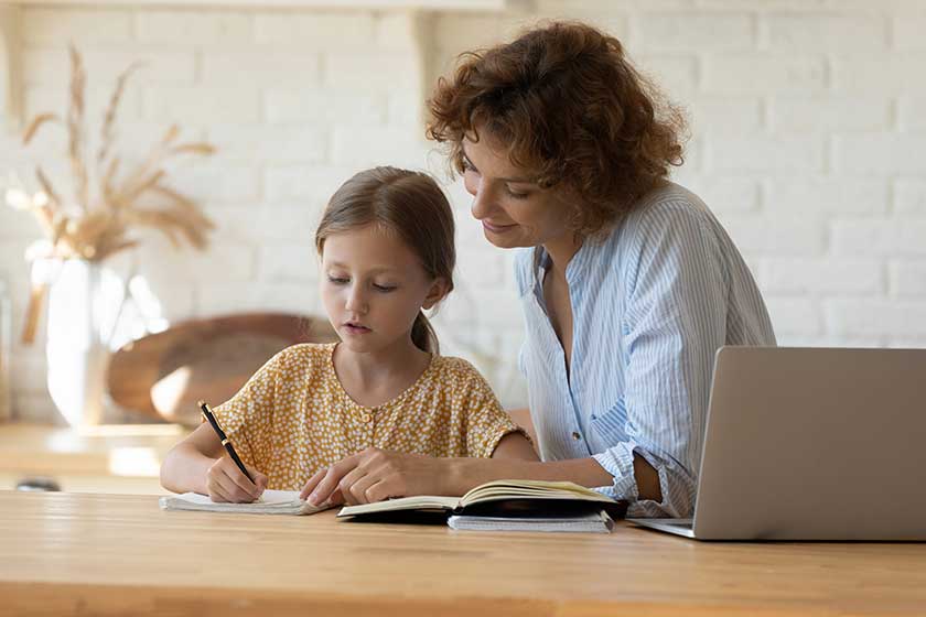 Young woman tutor giving private lesson to little girl